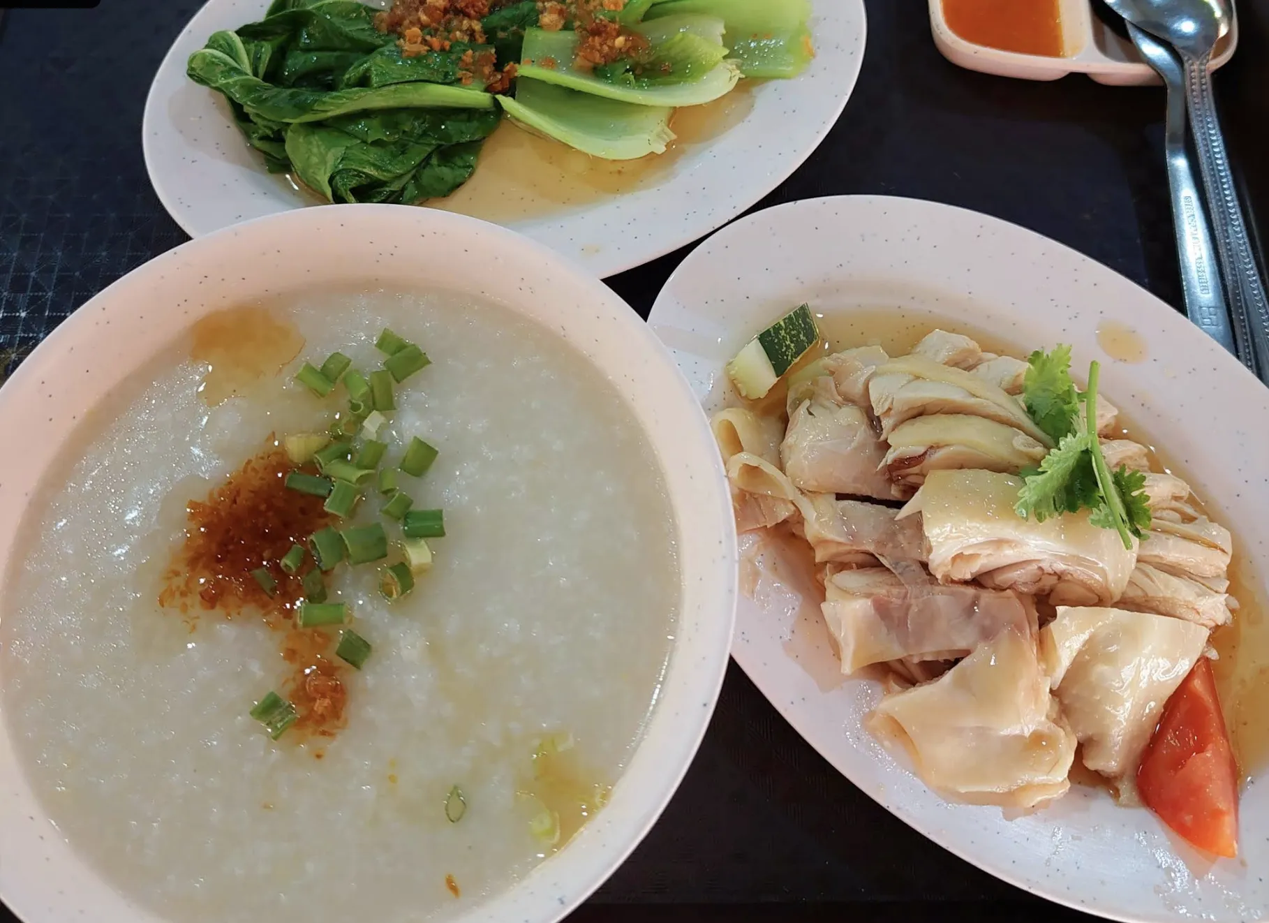 Image Chicken rice stall in Clementi known for its roasted chicken rice and flexible portion options, great for both solo meals.