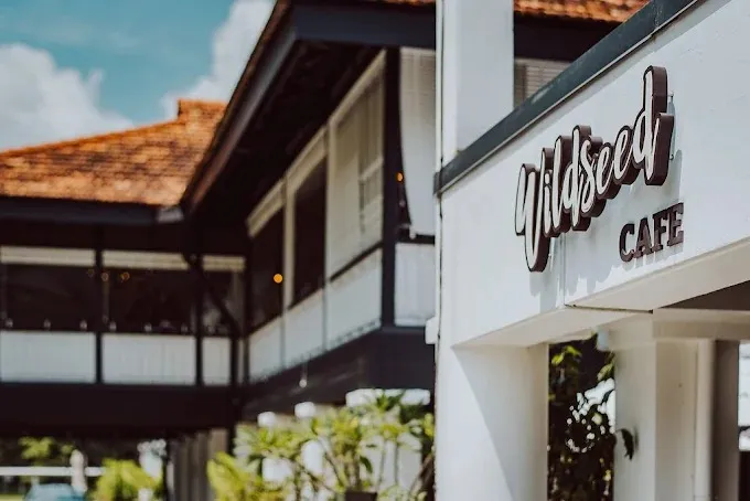 Image a pet-friendly, garden-themed cafe located on the ground floor of The Summerhouse at Seletar Aerospace Park